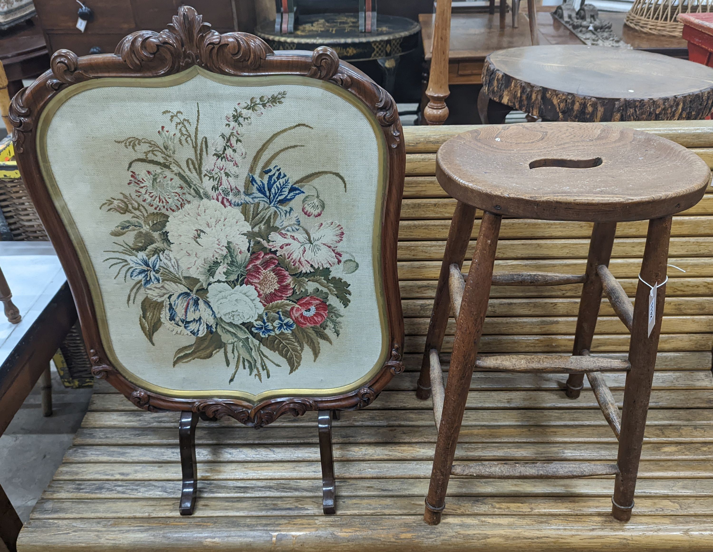 An elm and beech stool together with a Victorian rosewood tapestry firescreen